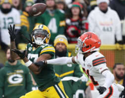 Packers wide receiver Davante Adams (17) catches a pass under coverage by Browns cornerback Denzel Ward (21) during the first half at Lambeau Field in Green Bay, Wis., Saturday, Dec. 25, 2021.