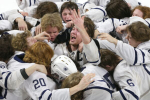 Hudson’s Zach Kochendorfer, center, celebrates the team’s victory over Edgewood in the Division 1 State Boys Hockey Championship game at the Alliant Energy Center in Madison, Wis., Saturday, March 5, 2022. 