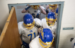 The Charges strap on their helmets and exit the Boy’s locker room to take on the Kenesaw Blue Devils on Wednesday, Oct. 31, 2018, during the second round of Class D-2 playoffs in Kenesaw.