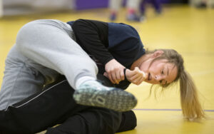 Jerzie Menke practices with a teammate as they prepares for their district meet.