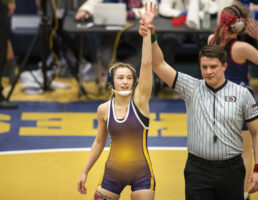 Bridgeport’s Jerzie Menke won the very first girls state title at 126-pounds. Menke said it took a few minutes to realize what she had just accomplished. Bridgeport wrestling coach Zach Malcolm said the hard work Menke put in culminated with a good day of wrestling, and he was proud to place the medal around her neck. He compared the moment to awarding the Class C 106 pound medal to Casey Benavides at boys state wrestling in 2019.