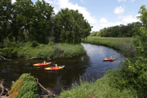 Kayakers float down Badfish Creek near Leedle Mill Road, north of Cooksville, Wis., Wednesday, July 20, 2022. Clark Conway, not pictured, the owner of Drift Away Paddle Company, helped launch the kayakers at Badfish Creek State Wildlife Area where they started their three-hour trip. This is Conway’s seventh season offering rentals and shuttle services for trips down the lower Yahara River and Badfish Creek. “Business really got crazy after the pandemic,” Conway said. 