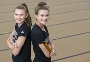 Nebraska Wesleyan track and field athletes and twin sisters Kaylee Jones (left) and Elizabeth pose for a portrait Monday, May 20, 2019, at the Woody Greeno Track and Field Facility.