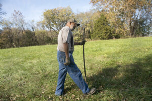 T.J. Cooper walks his farm land to survey the damage to his fence Thursday, Oct. 26, 2016, in Fulton, Missouri.